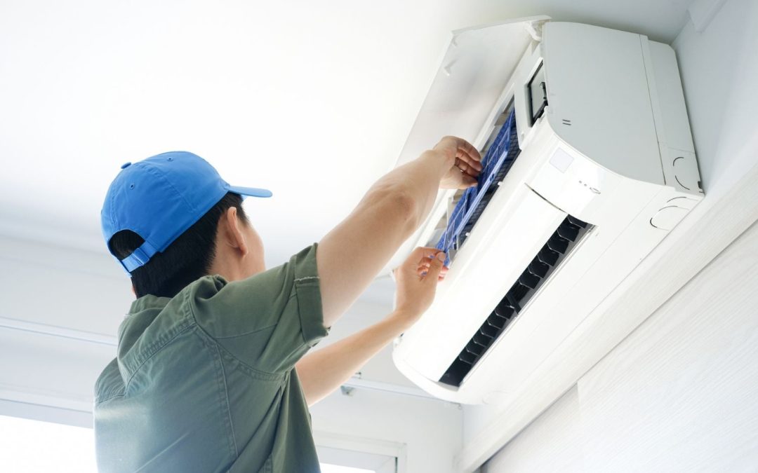 HVAC technician servicing a ductless mini split in Riverside
