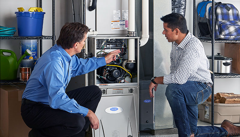 Technician evaluating a furnace for repair or replacement in Riverside