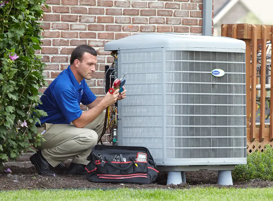 HVAC technician inspecting an outdoor AC unit in Riverside