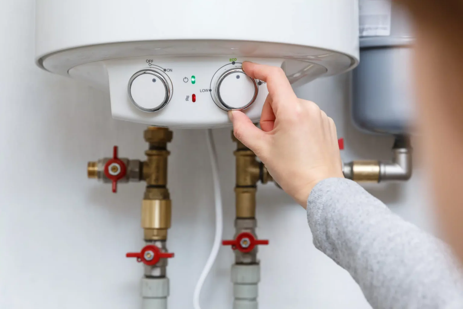 Technician adjusting a water heater in Riverside